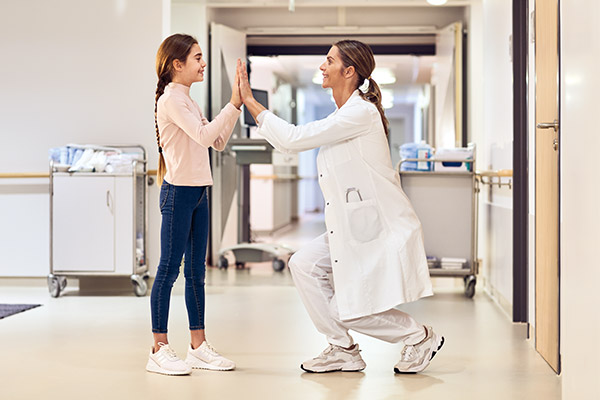 pediatrics doctor with patient girl on hallway